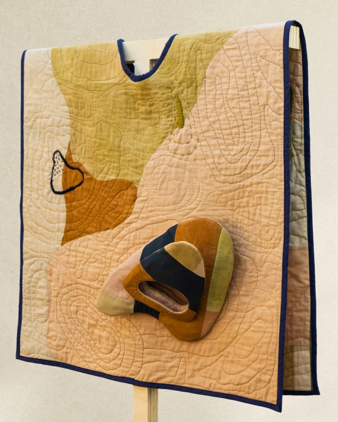 An image of a wearable quilt, artwork.