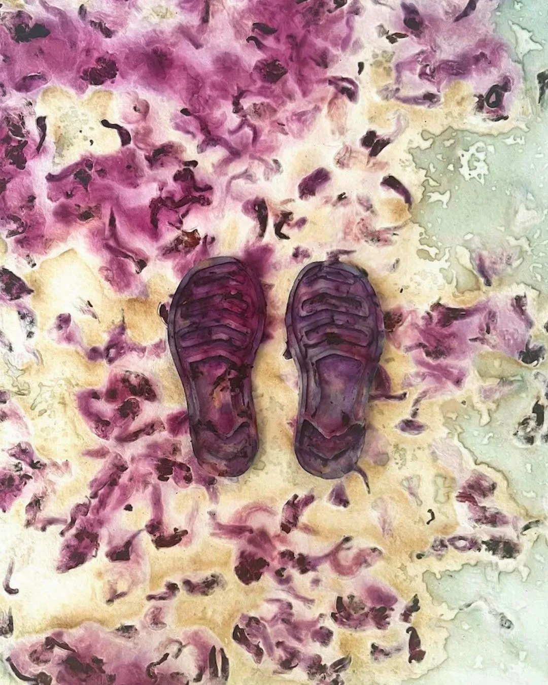 An artwork with a pair of purple shoes on a multicolour surface