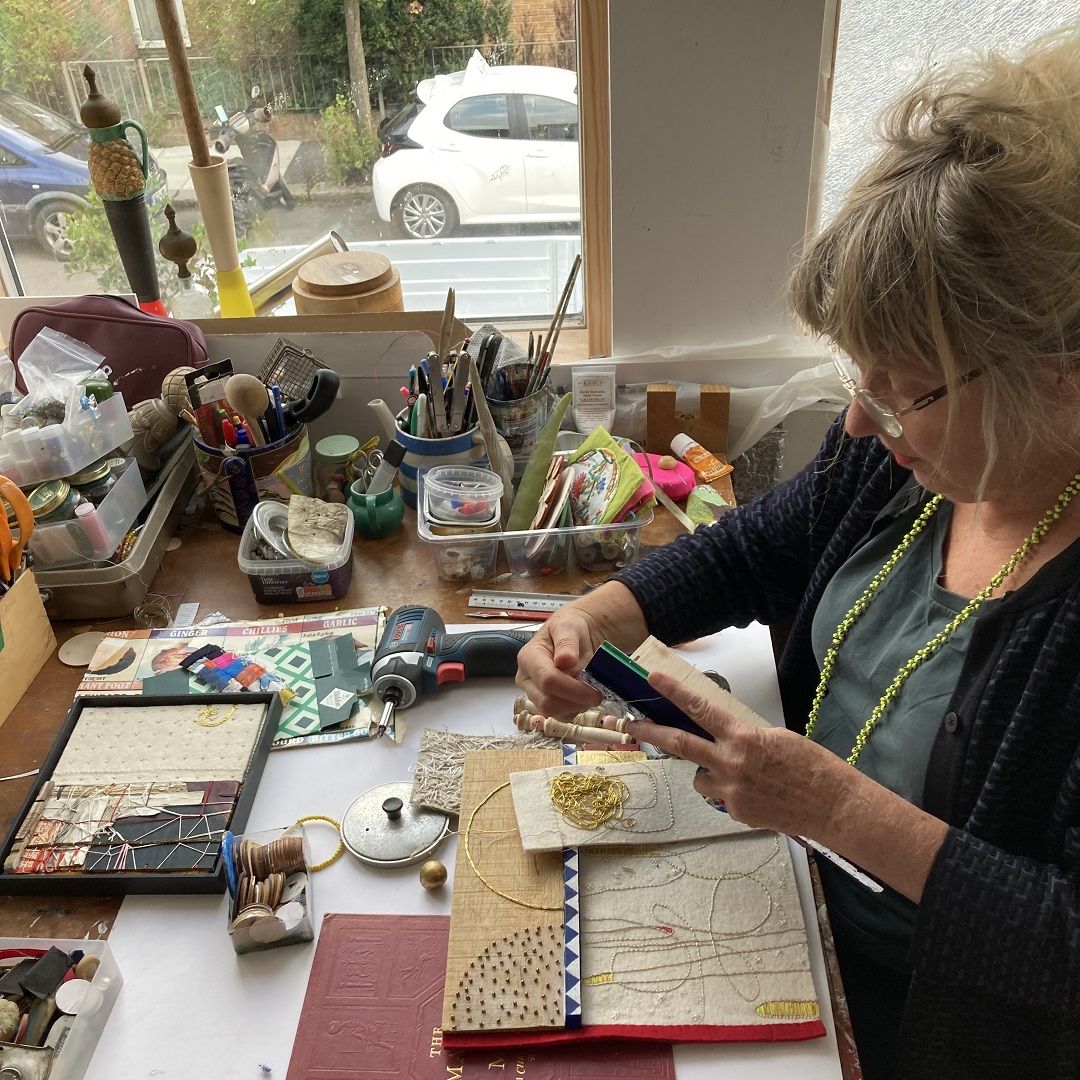 Louise Baldwin working in her studio. - TextileArtist.org