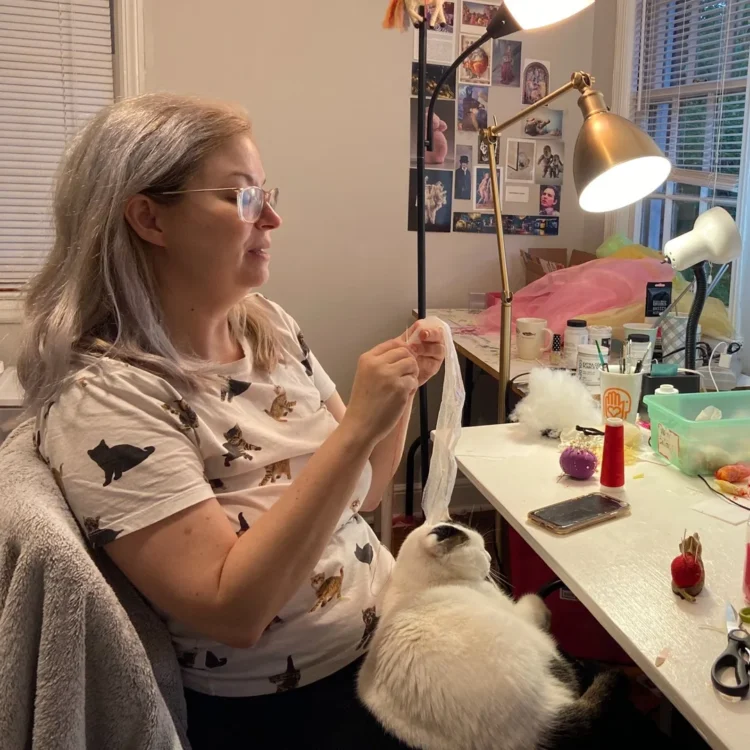 Kelly Boehmer and her cat Sparkles, in her home studio.