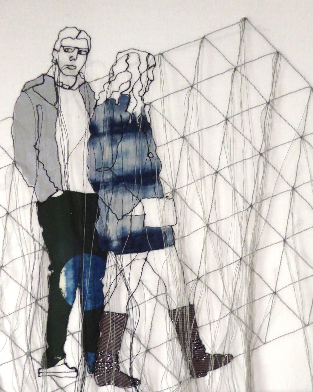 A stitched artwork depicting a man and woman taking a walk in the foreground with a grey grid representing a building behind them in the background