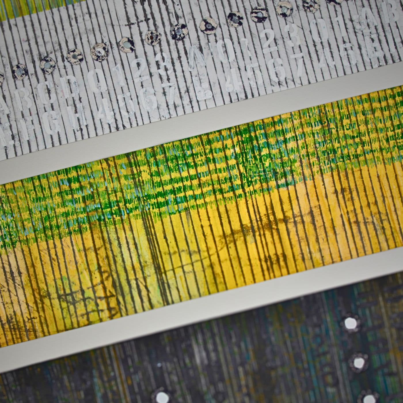 A close up of a stitched artwork with three fabric strips.