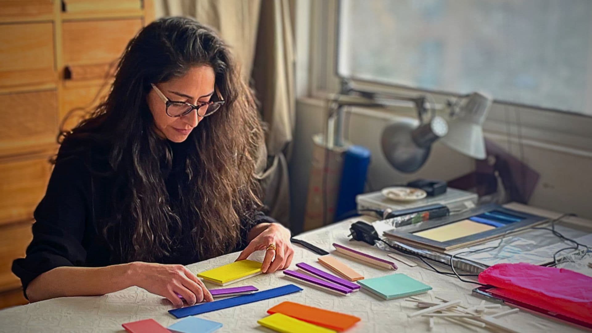 Andrea Barrios Aguilar in her studio working on a piece of textile art.