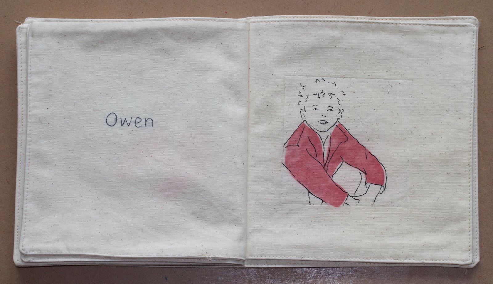 Andrea Cryer: etching - photograph of pages from the etched soft fabric book, showing my son and hand-stitching