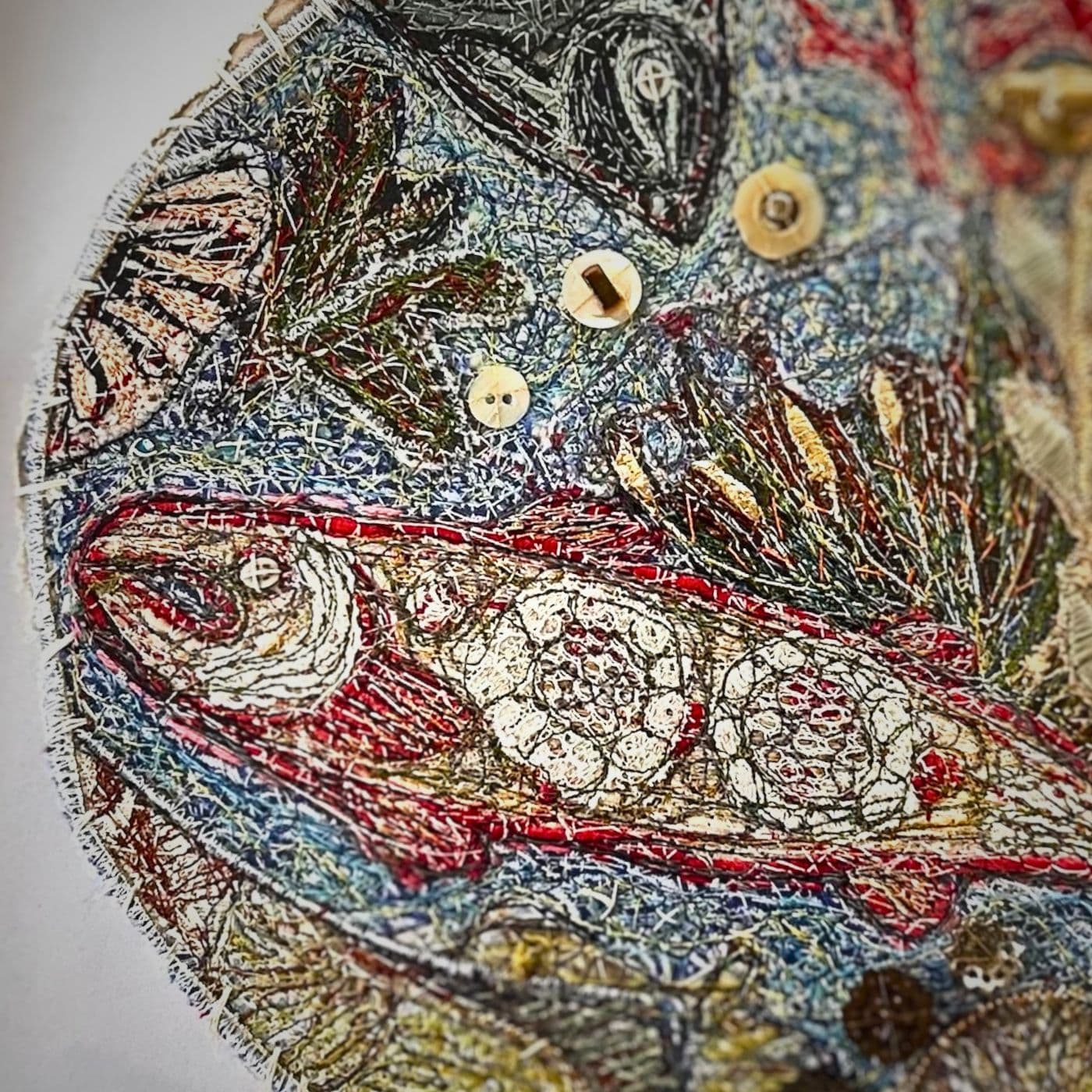 A close up of a fish stitched artwork