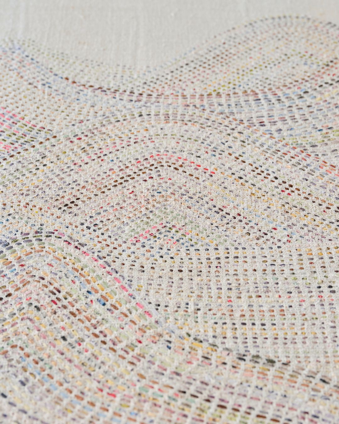 A closeup detail of hand stitched artwork