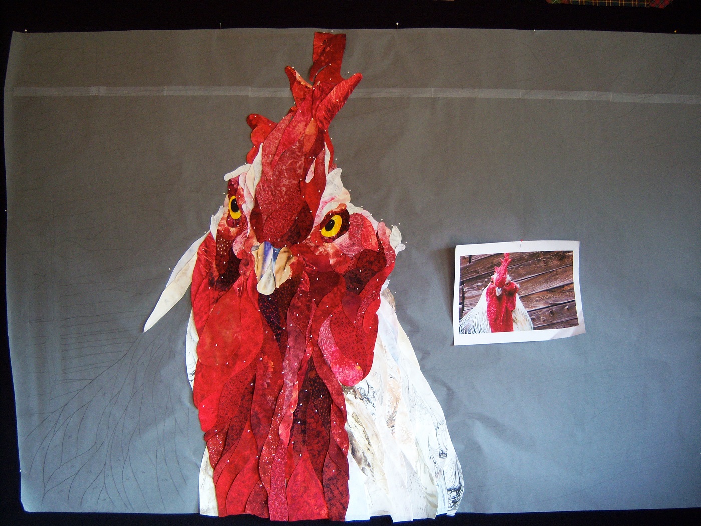 David Taylor: Cock of the Walk, in progress (Detail), 2012, 59w x 39h, cotton fabrics, cotton batting, variegated cotton quilting threads; hand applique, machine quilting