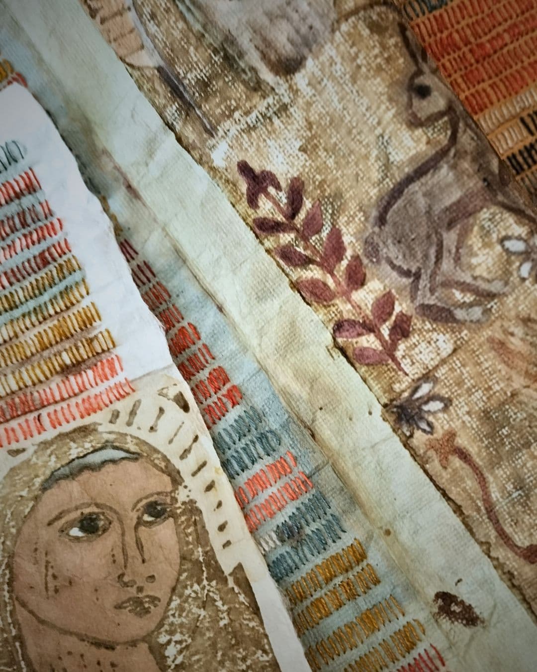 A close up of a stitched artwork with a medieval inspired portrait.