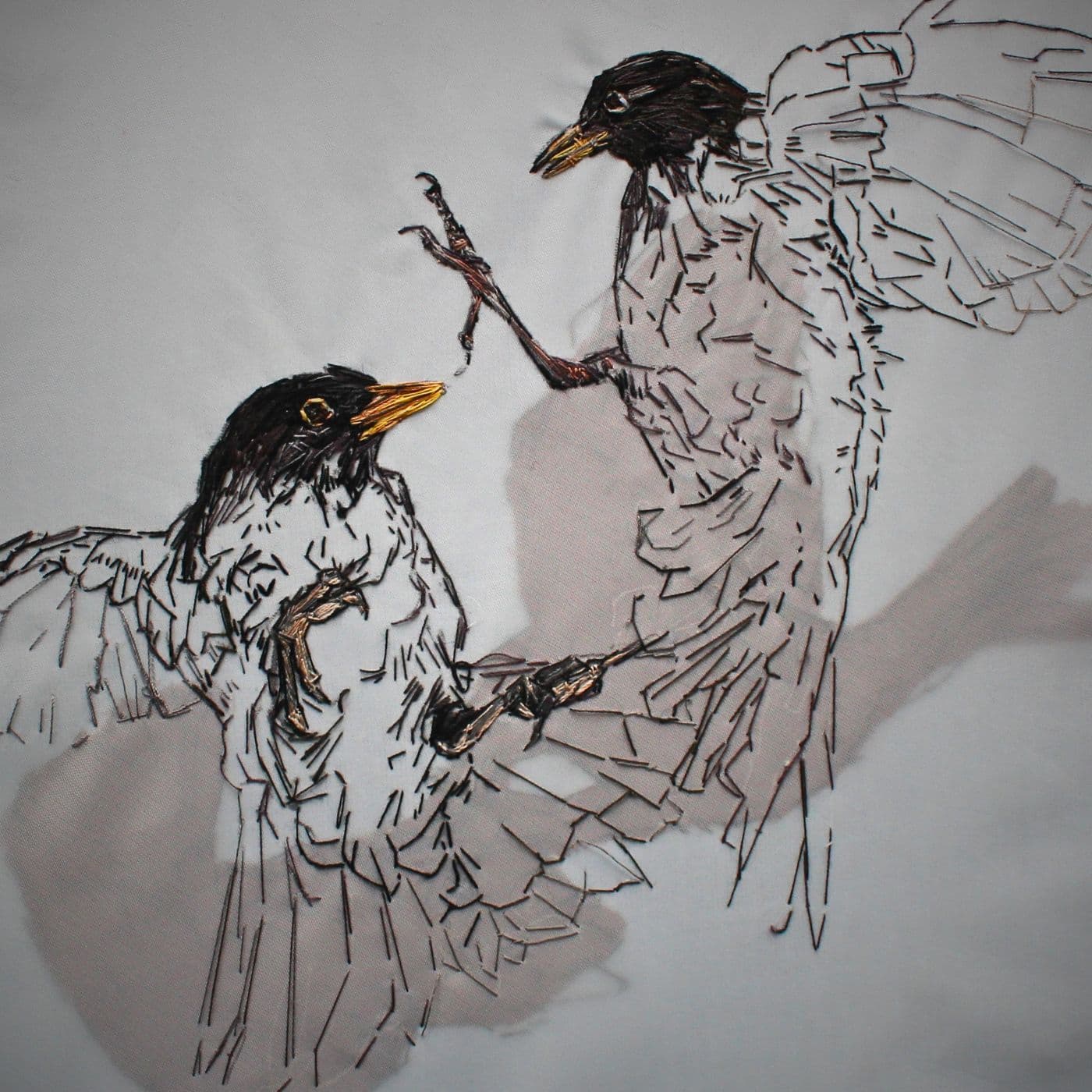 a bird embroidery on a white surface