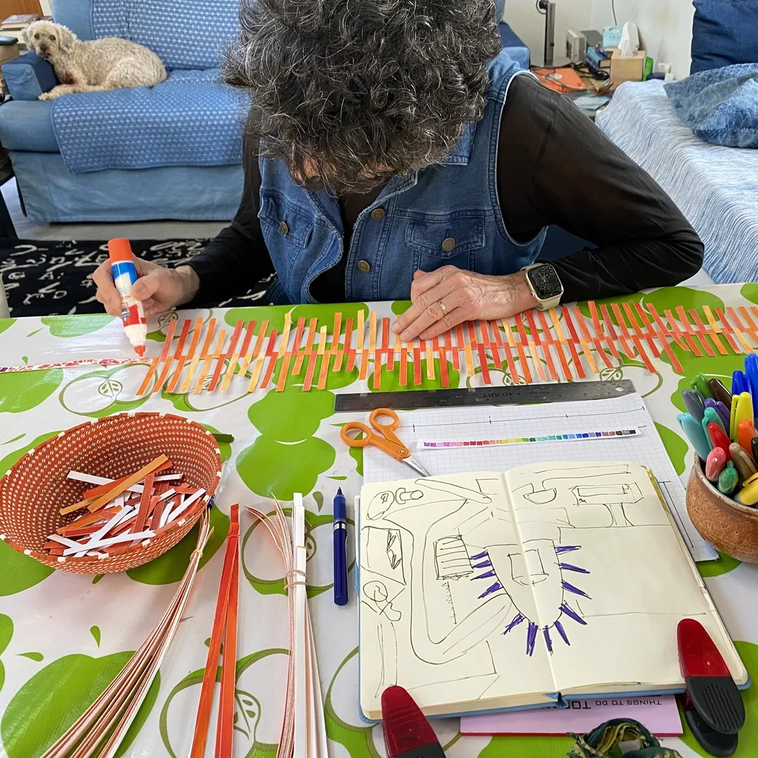 Daniella, glueing paper to a ‘spine’ (with canine companion).