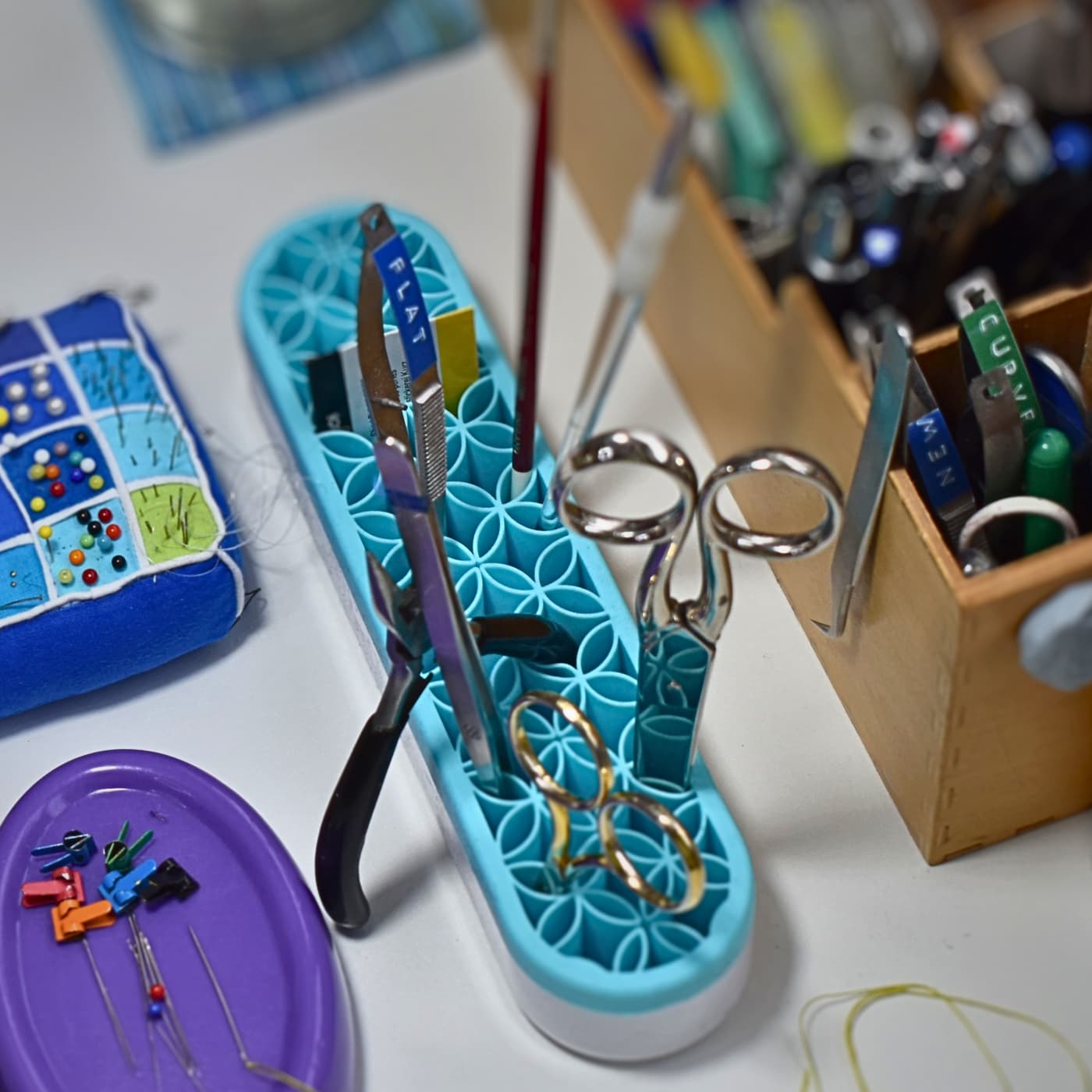 a blue container with scissors and other objects on it