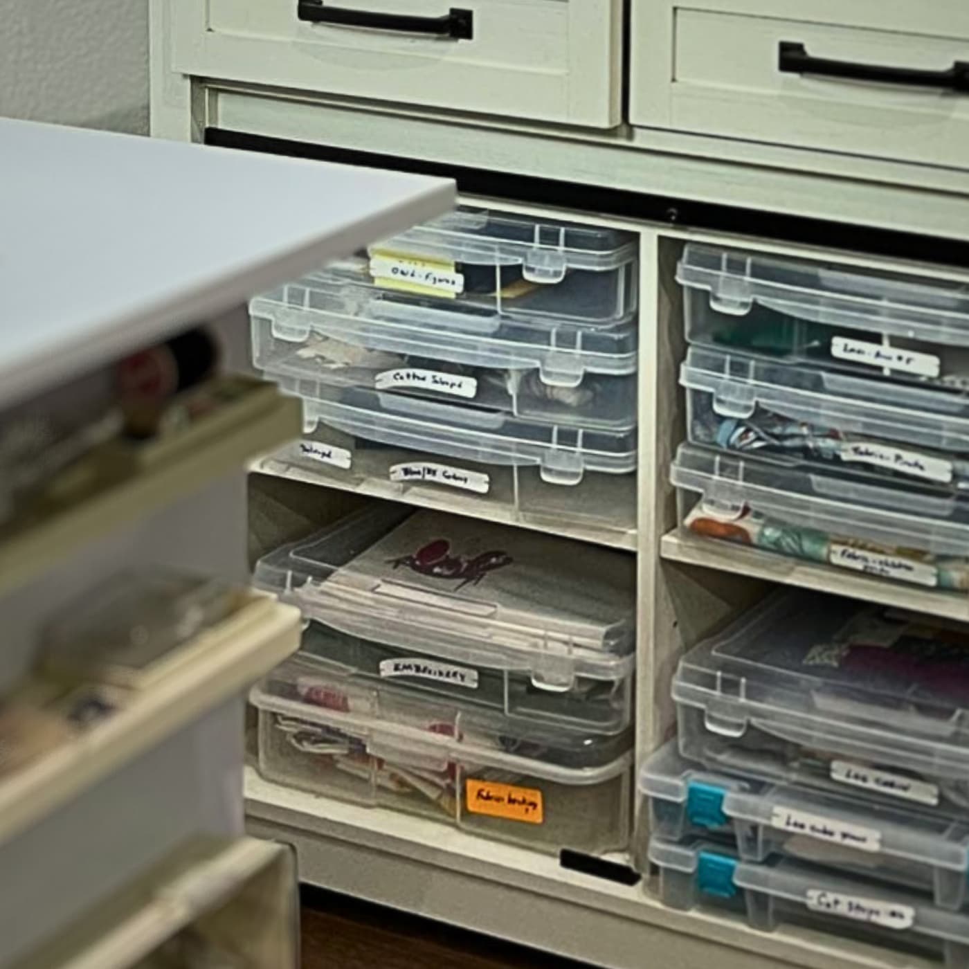 a shelf with plastic bins and a white table