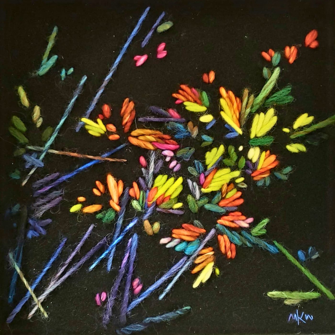 a colourful embroidery on a black surface