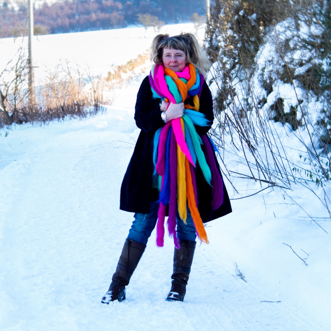 Moy Mackay in the snow, wrapped in merino fibres