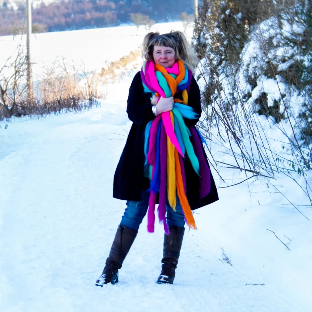 Moy Mackay in the snow, wrapped in merino fibres