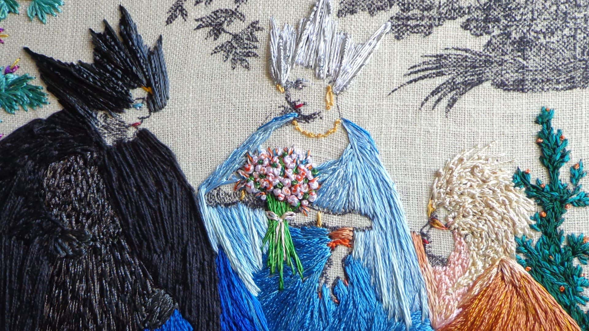 An embroidery of three figures deep in conversation.