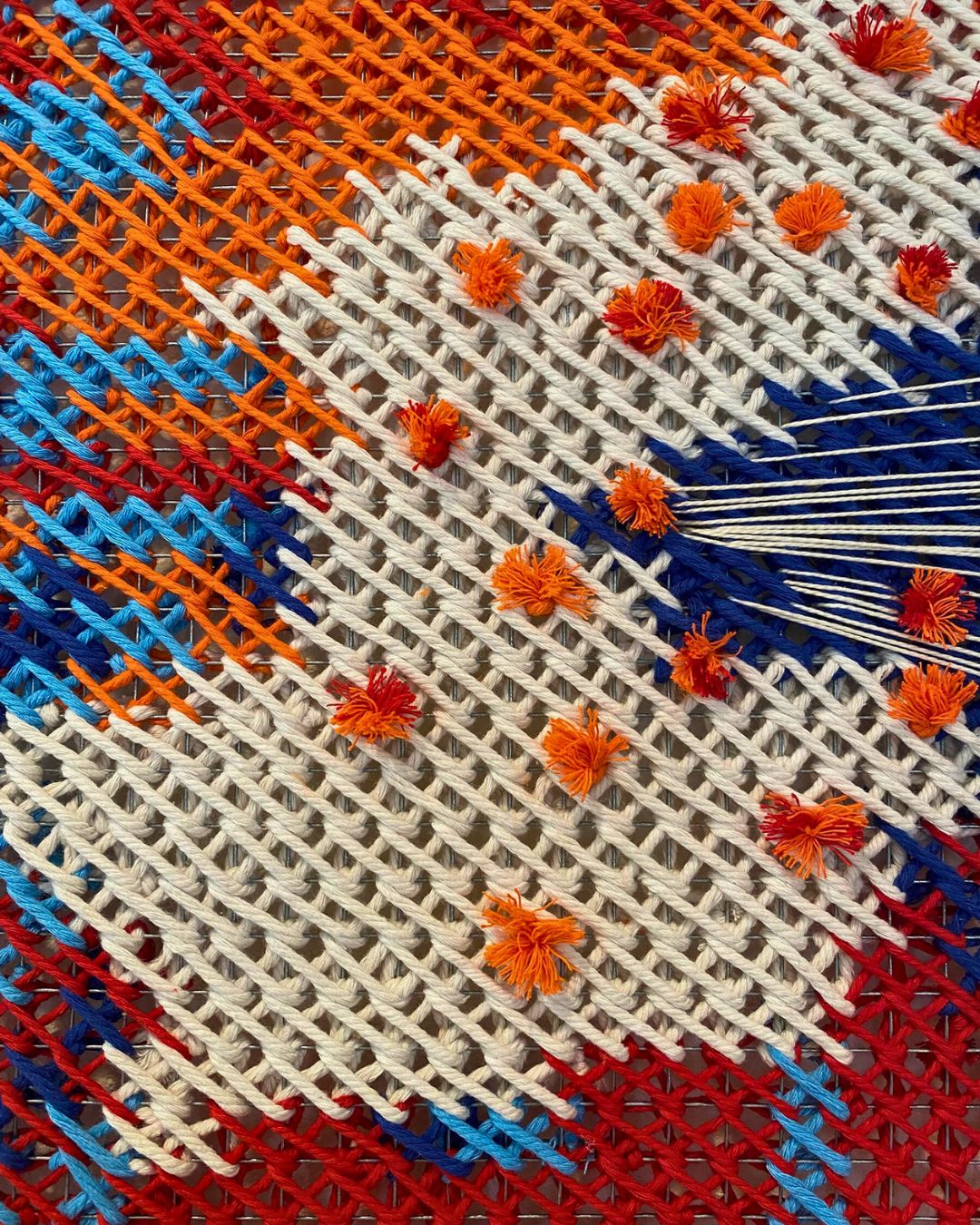 a close up of a woven fabric artwork.