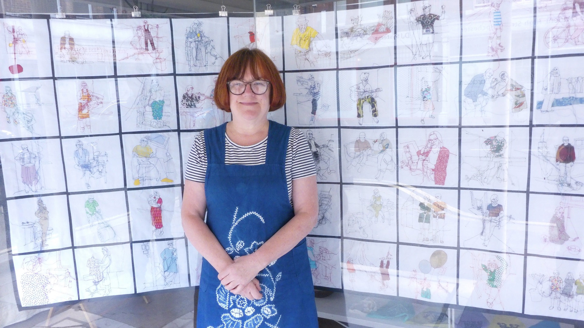 Rosie James stood outside the Intra Gallery, in front of her work hanging in the window. Photo: Mark Hair