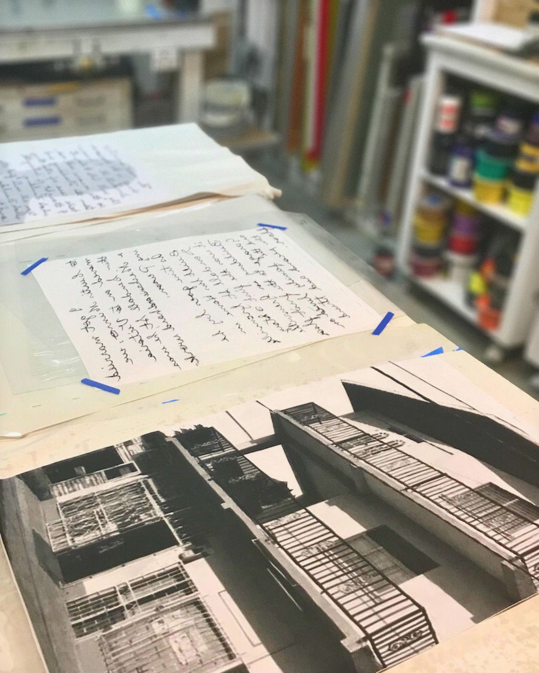 Print samples lined up across a work surface in a printers studio