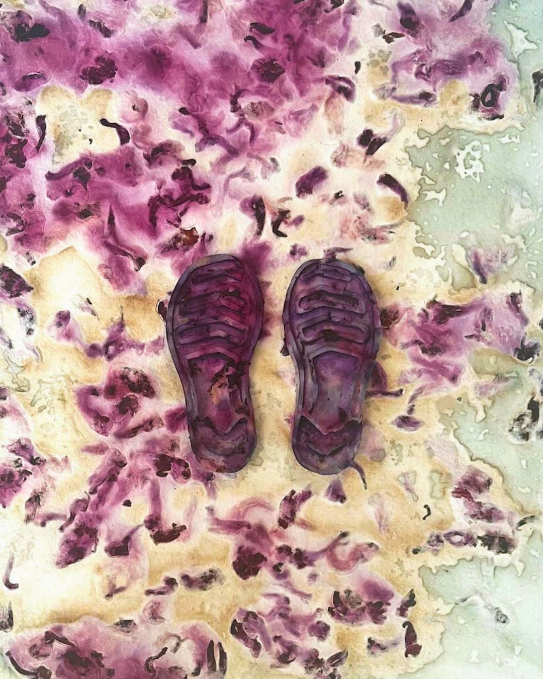 An artwork with a pair of purple shoes on a multicolour surface