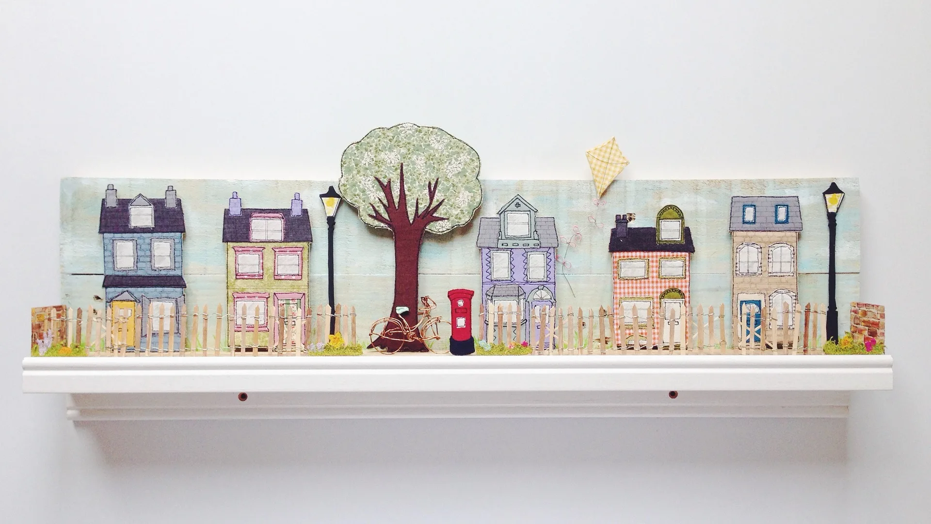 Katie Essam, Suburban Life (detail), 2016. 75cm x 20cm x 10cm (30" x 8" x 4"). Free motion embroidery, appliqué, painting, woodwork, wire work. Fabric, thread, wood, wire, acrylic paint, paper, soluble fabric, found objects, nail varnish, shelf base.