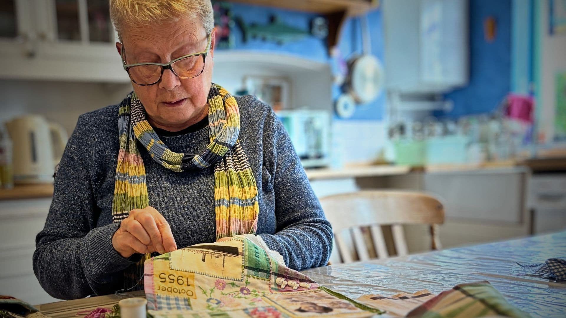 Sue Partington stitching at her kitchen table in Brighton, her preferred work space.