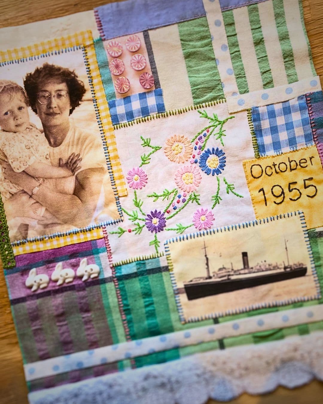 a quilt with pictures of a woman and a child and a ship.