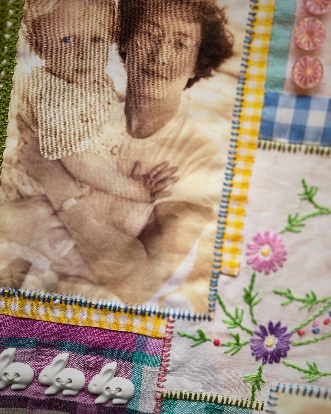 a quilt with a picture of a woman holding a baby