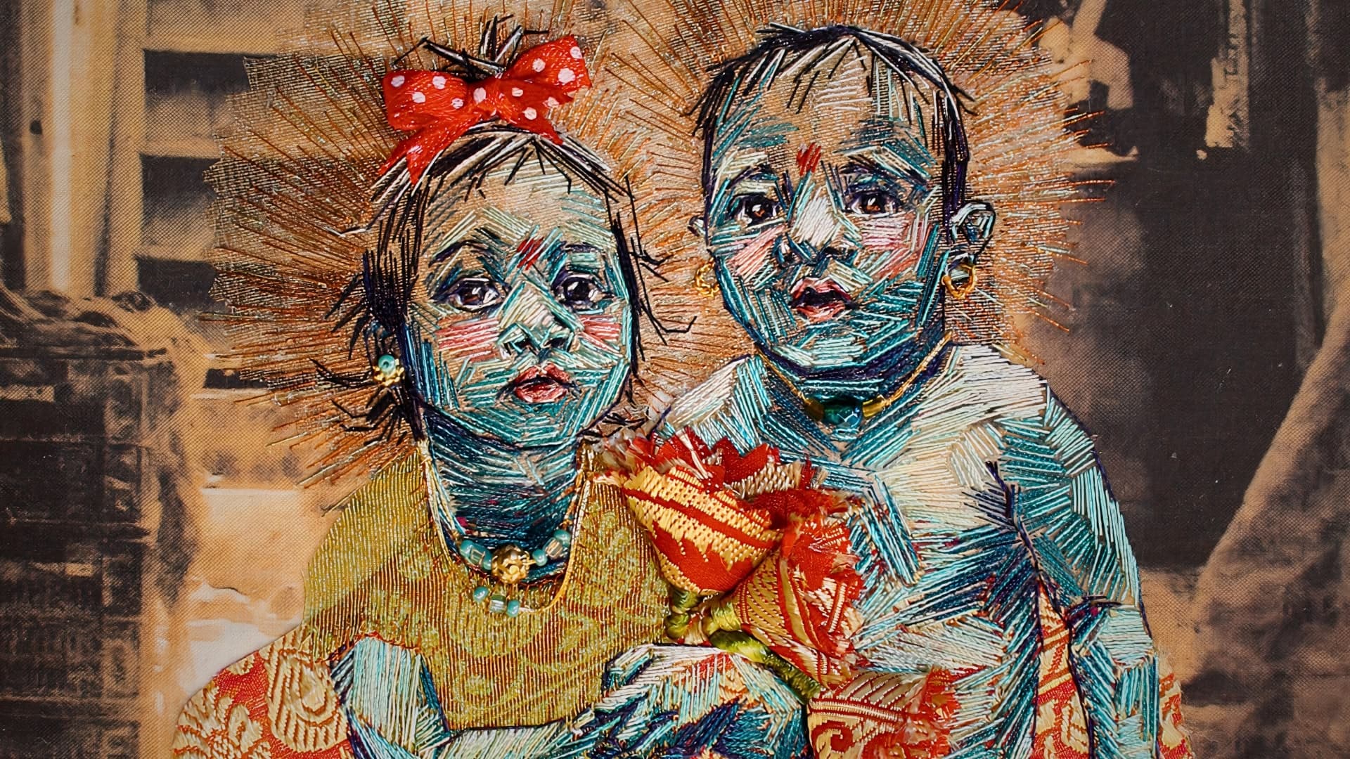 a close up of a embroidery of a boy and girl