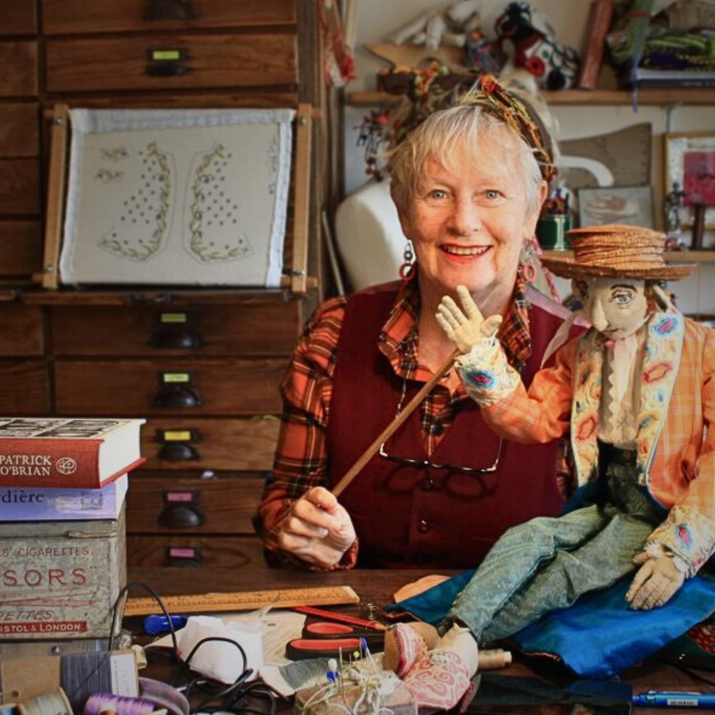 a woman sitting at a table with a doll