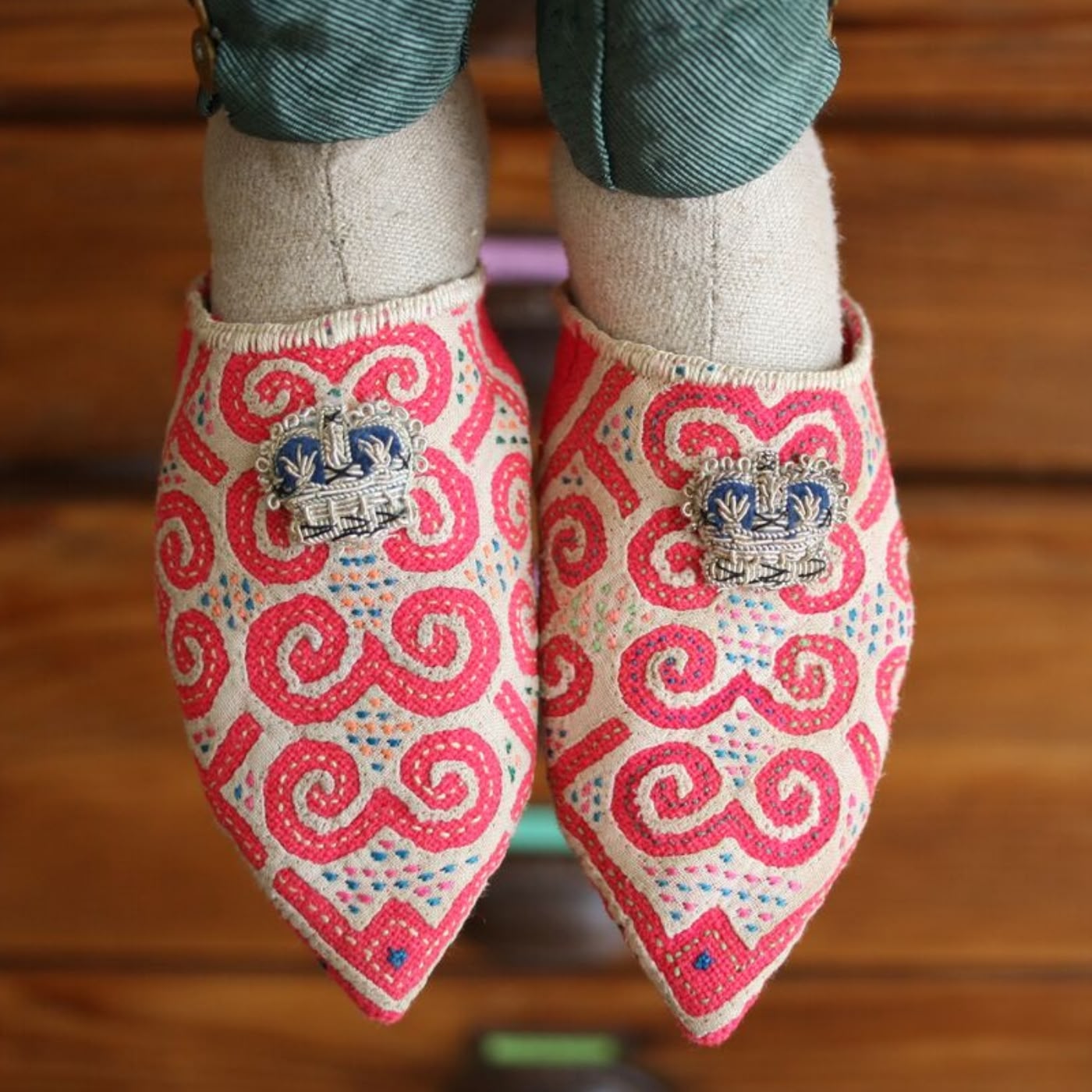 a puppet's feet wearing red patterned slippers