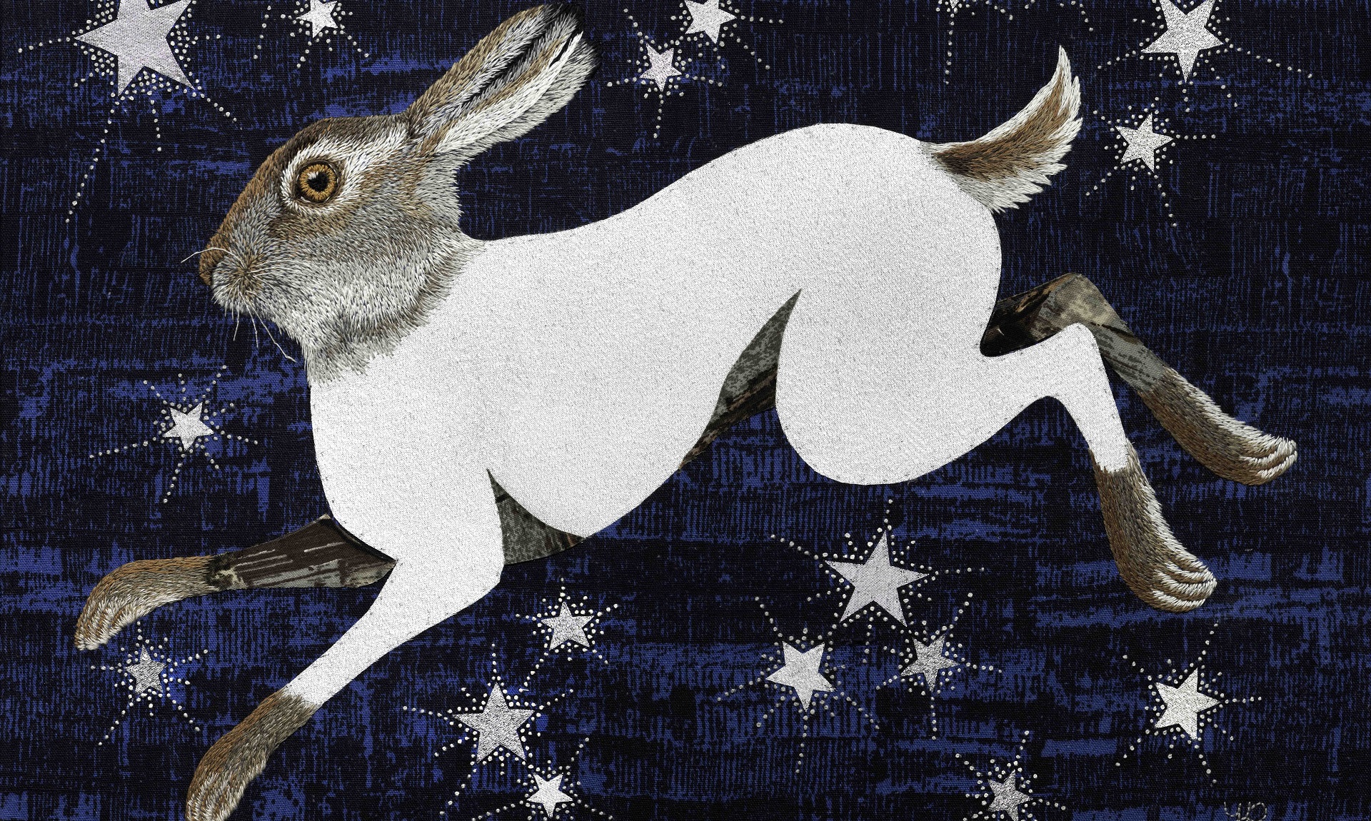 An embroidery of a rabbit on a blue night's sky, starry background.