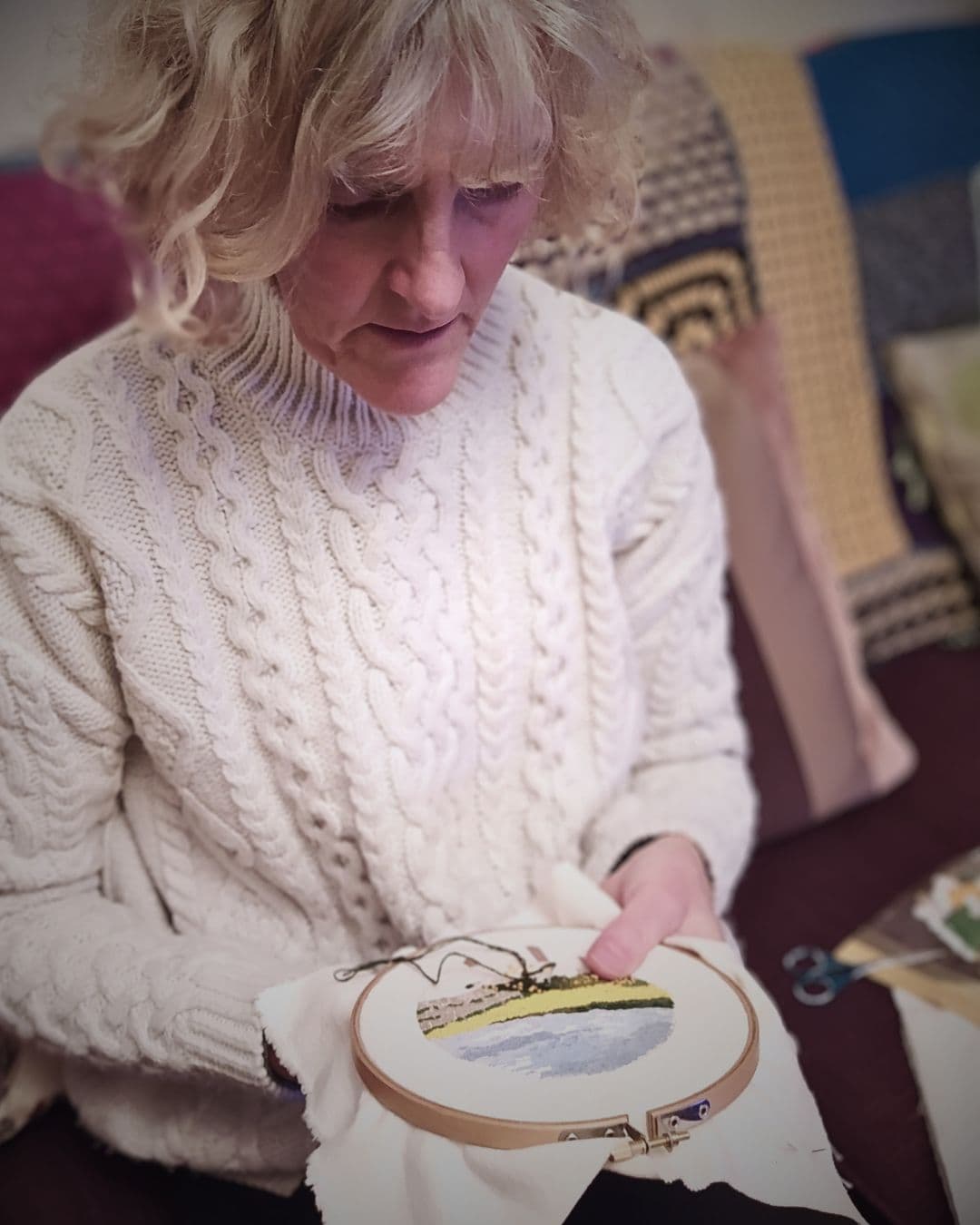 Val Fisher stitching in her home in Newcastle, UK.