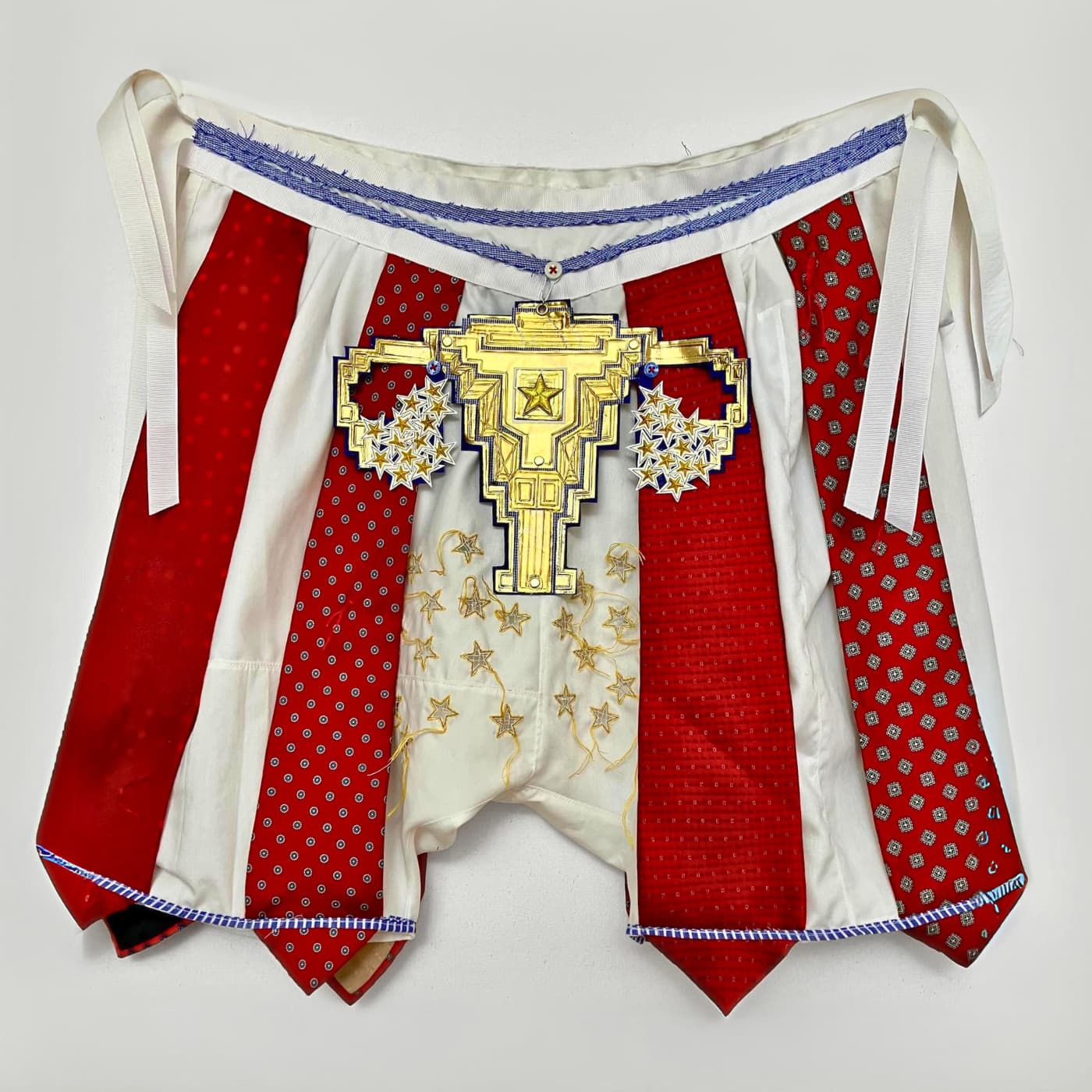 Red and white shorts with a gold trophy over the crotch. 