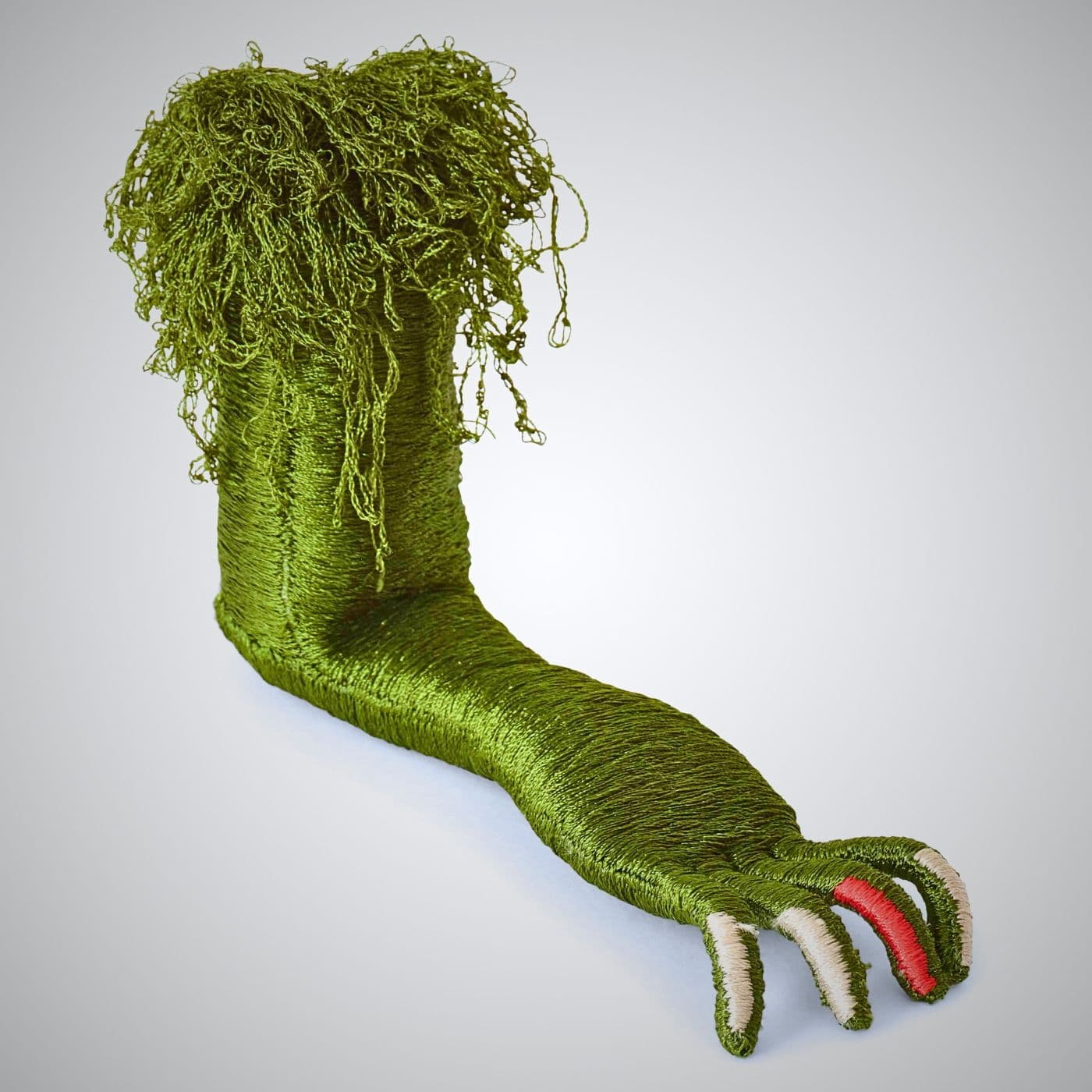 A stitched sculpture of green stuffed animal foot.