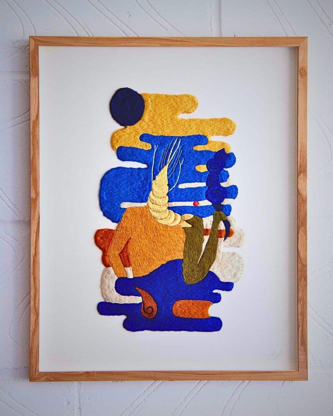 A framed picture of a person with a blue and yellow design