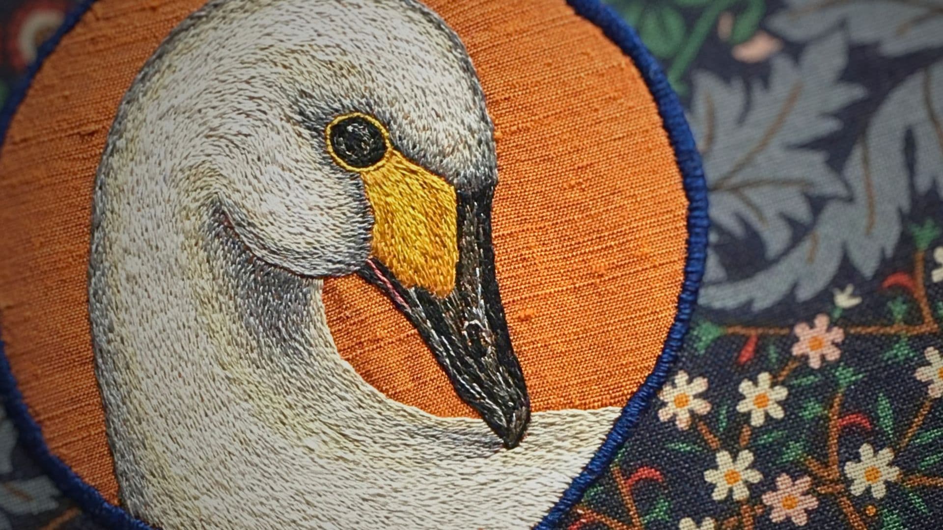 A close up of an embroidered swan