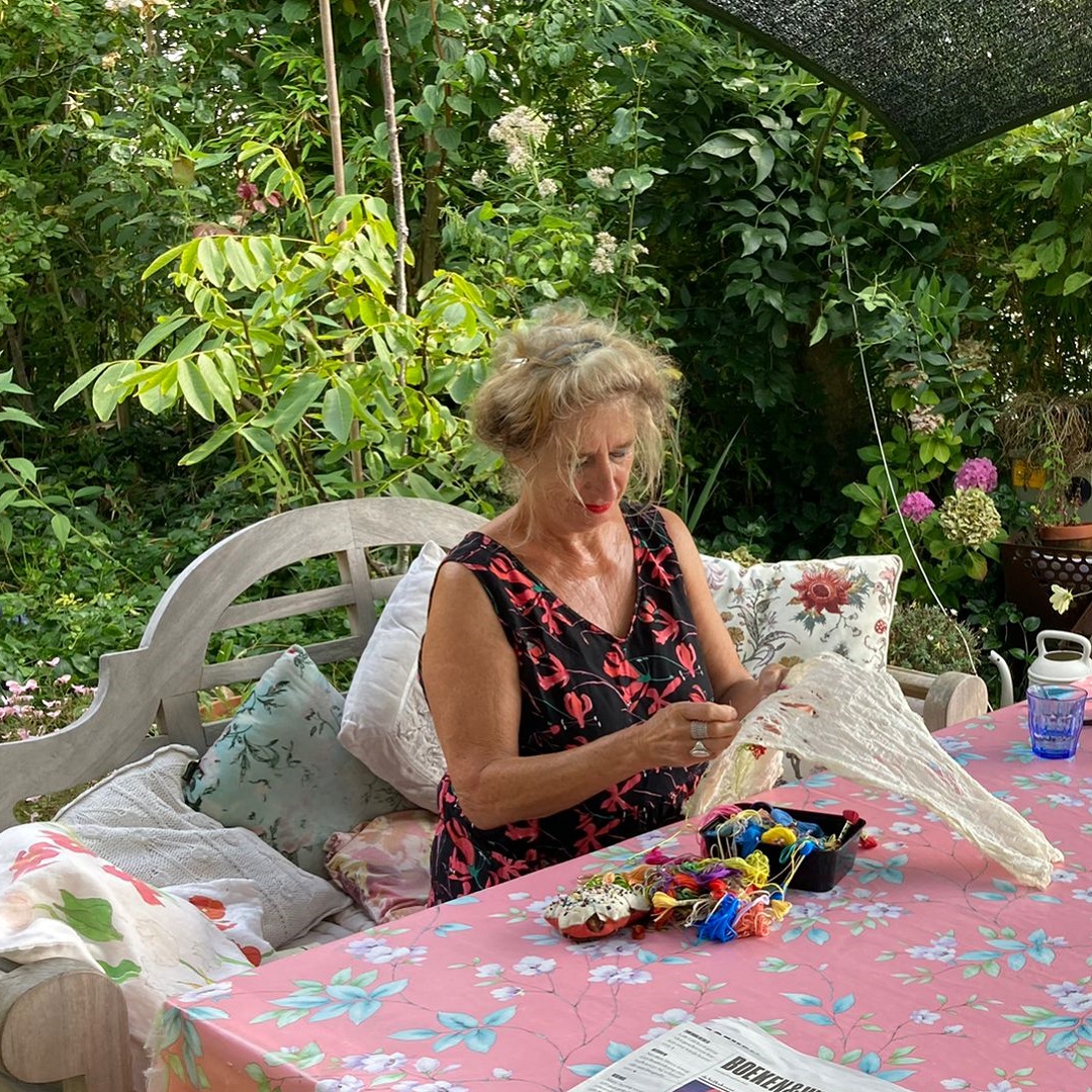 Mathilde Renes stitching at her garden table. Photo: Onno van den Brink